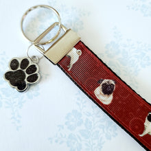 Load image into Gallery viewer, Pugs and Swirls Key Fob with Enameled Paw Print Charm
