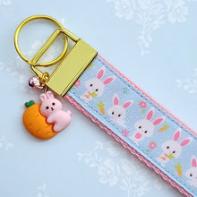 Load image into Gallery viewer, Bunnies with Carrots &amp; Flowers on Light Blue Yellow Gold Key Chain Fob with Enameled Bunny Charm
